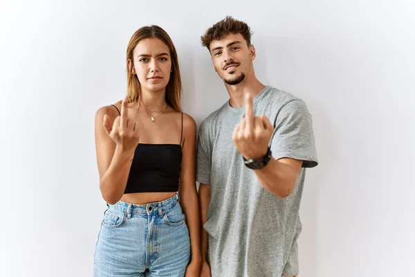 Young Beautiful Couple Standing Together Isolated Background Showing Middle Finger — Fotografia de Stock