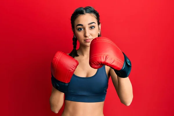 Young Brunette Girl Using Boxing Gloves Relaxed Serious Expression Face — Fotografia de Stock