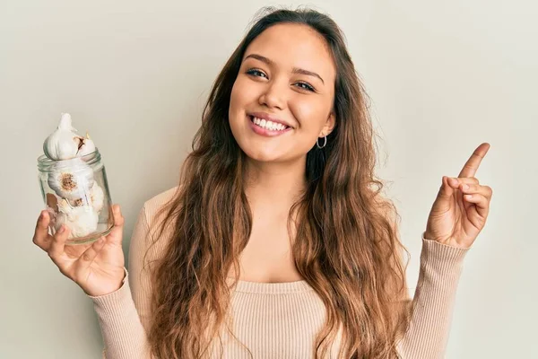 Jong Hispanic Meisje Houden Glas Knoflook Glimlachen Gelukkig Wijzend Met — Stockfoto