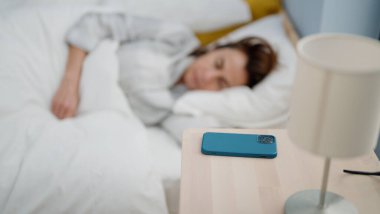 Orta yaşlı İspanyol kadın yatak odasında uyuyor.