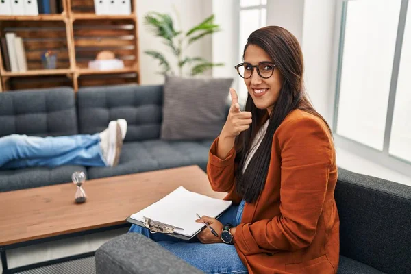 Young Hispanic Woman Working Psychology Counselor Pointing Fingers Camera Happy — стоковое фото