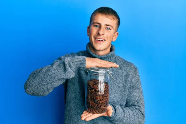 Young Caucasian Man Holding Jar Raisins Smiling Laughing Hard Out — стоковое фото