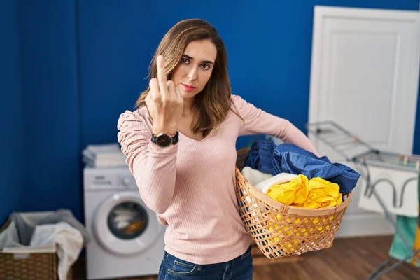 Young Woman Holding Laundry Basket Showing Middle Finger Impolite Rude — ストック写真