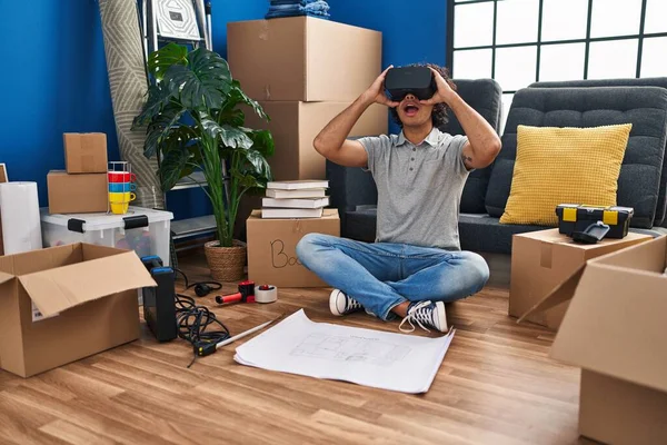 Young Hispanic Man Suprised Using Virtual Reality Glasses New Home — Stockfoto