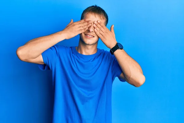 Young Caucasian Man Wearing Casual Blue Shirt Covering Eyes Hands — Foto Stock