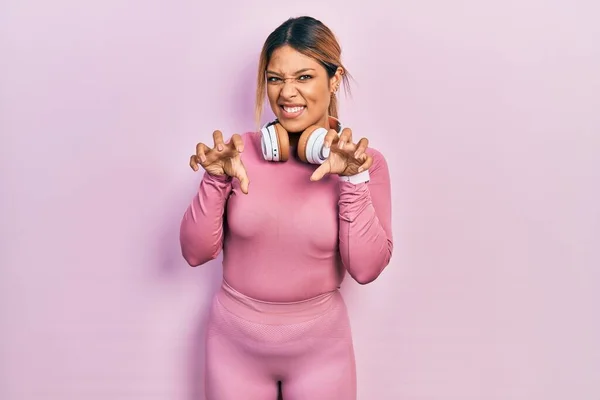Beautiful Hispanic Woman Wearing Gym Clothes Using Headphones Smiling Funny — стоковое фото