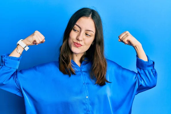 Young Brunette Woman Wearing Casual Blue Shirt Showing Arms Muscles — Stockfoto