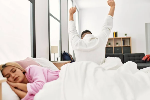 Man Waking Stretching Arms Woman Sleeping Lying Bed Home — Stockfoto