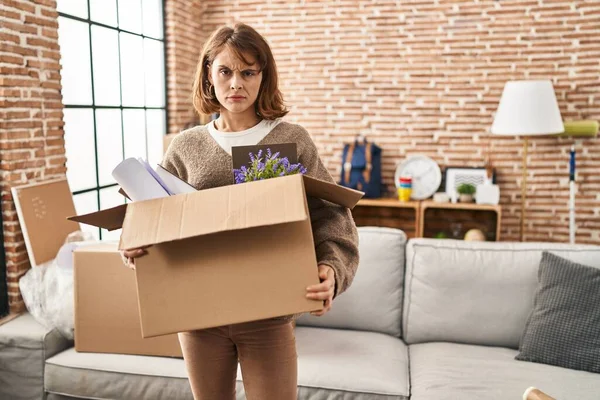 Young Beautiful Woman Holding Box Moving New Home Skeptic Nervous — Stockfoto