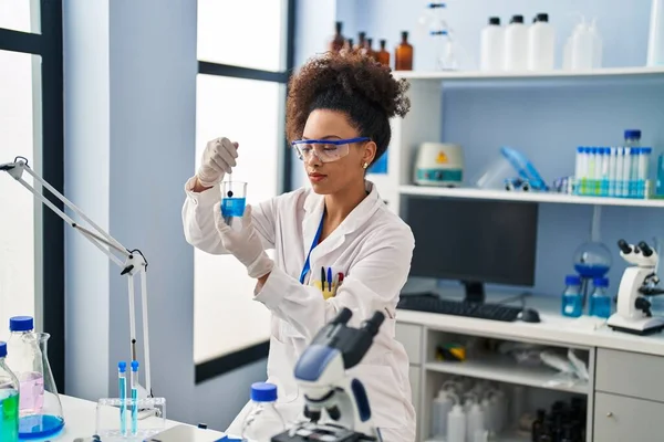 Young African American Woman Wearing Scientist Uniform Mixing Liquid Laboratory —  Fotos de Stock