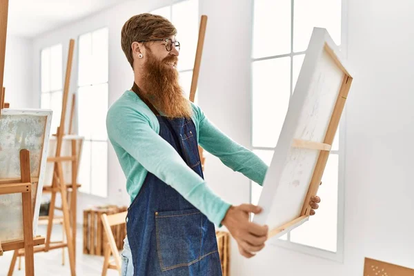 Young Redhead Man Smiling Confident Holding Canvas Draw Art Studio — ストック写真