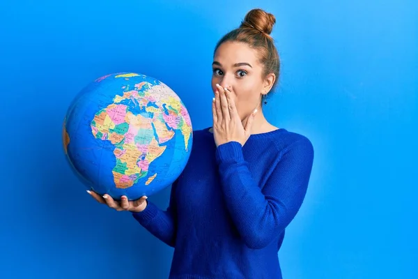 Young Blonde Woman Holding World Ball Covering Mouth Hand Shocked — Stock Photo, Image