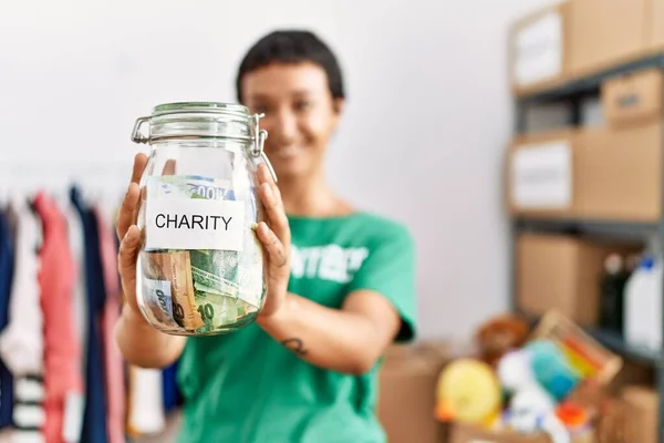 Young Hispanic Woman Wearing Volunteer Uniform Holding Jar Money Charity — Stok fotoğraf