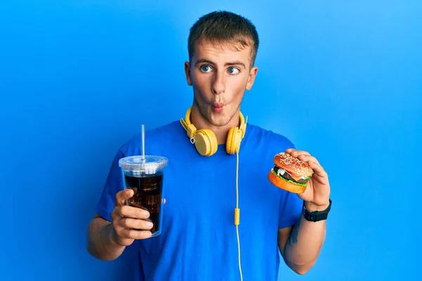 Young Caucasian Man Eating Tasty Classic Burger Soda Making Fish — Foto de Stock