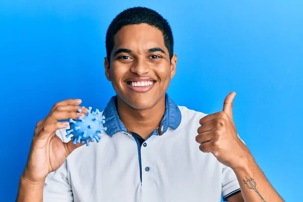 Young Handsome Hispanic Man Holding Virus Toy Smiling Happy Positive — Stock Photo, Image