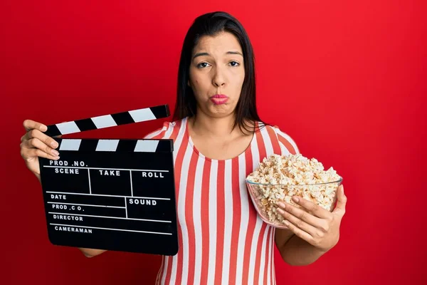Młoda Latynoska Trzymająca Film Wideo Klapką Popcornem Depresji Martwiąca Się — Zdjęcie stockowe
