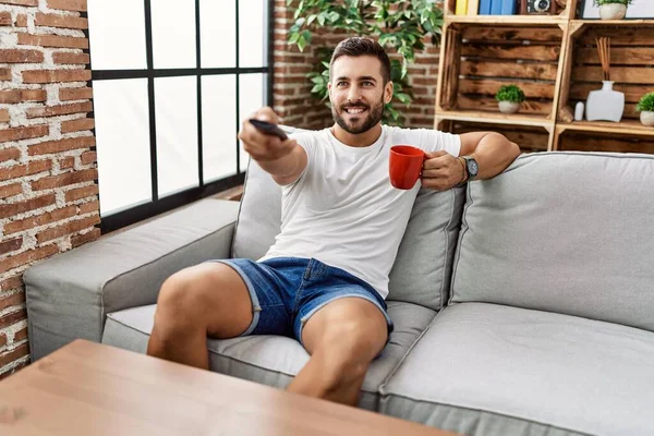 Young Hispanic Man Drinking Coffee Watching Home — Stock Photo, Image