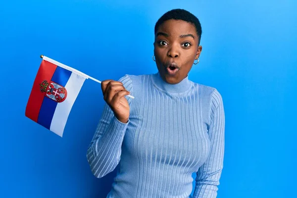 Young African American Woman Holding Serbia Flag Scared Amazed Open — Stockfoto