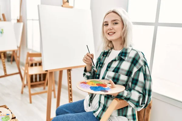 在艺术工作室里 年轻的女艺术家微笑着快乐的绘画 — 图库照片