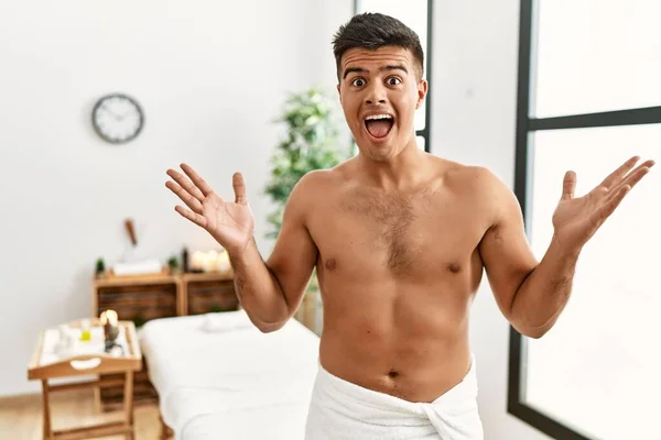 Young Hispanic Man Standing Shirtless Spa Center Celebrating Crazy Amazed — Stockfoto