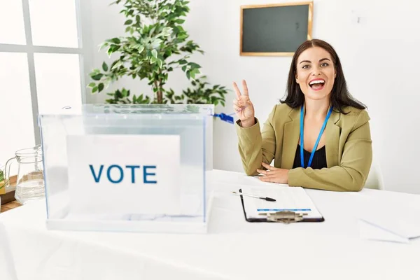 Young Brunette Woman Sitting Election Table Voting Ballot Smiling Happy — Stok fotoğraf