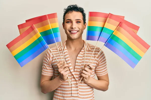 Hombre Guapo Usando Maquillaje Sosteniendo Banderas Arco Iris Lgbtq Sonriendo —  Fotos de Stock