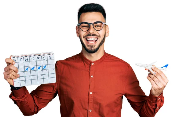 Young Hispanic Man Beard Holding Plane Toy Travel Calendar Smiling — Stock Photo, Image