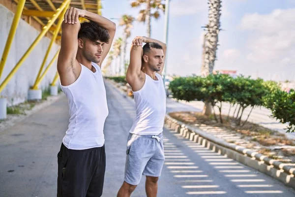 Two Hispanic Men Couple Stretching Street — Zdjęcie stockowe