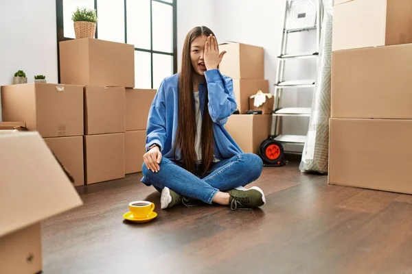 Young Chinese Girl Sitting Floor New Home Covering One Eye — Zdjęcie stockowe