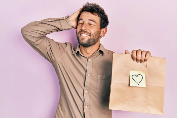 Handsome Man Beard Holding Delivery Paper Bag Heart Reminder Smiling — Fotografia de Stock