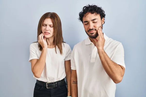 Young Couple Wearing Casual Clothes Standing Together Touching Mouth Hand —  Fotos de Stock