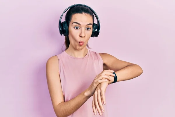 Young Brunette Woman Wearing Gym Clothes Using Headphones Smart Watch — Foto de Stock