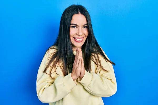 Young Brunette Woman Wearing Casual Sweatshirt Praying Hands Together Asking — 스톡 사진