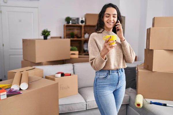 Young Hispanic Woman Talking Smartphone Drinking Coffee New Home — Fotografia de Stock