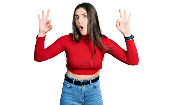 Young Brunette Teenager Wearing Red Turtleneck Sweater Looking Surprised Shocked — Stockfoto
