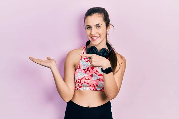 Young Brunette Teenager Wearing Gym Clothes Using Headphones Amazed Smiling — Foto de Stock