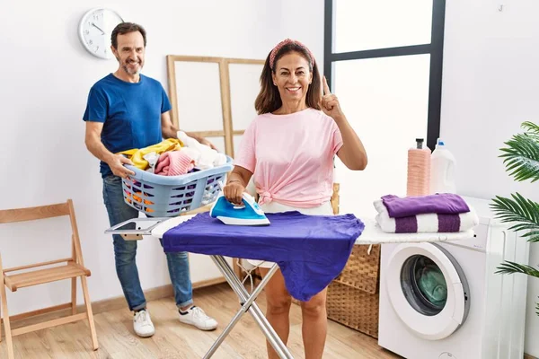 Middle Age Couple Ironing Clothes Home Smiling Idea Question Pointing — стоковое фото