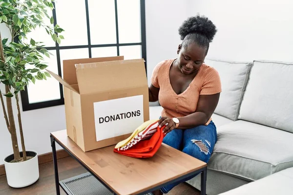 Young African American Woman Folding Clothes Donate Home — Stock Photo, Image