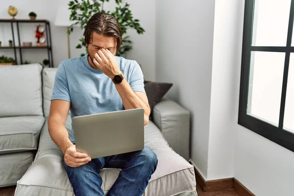 Handsome Middle Age Man Using Computer Laptop Sofa Tired Rubbing — Stock Photo, Image