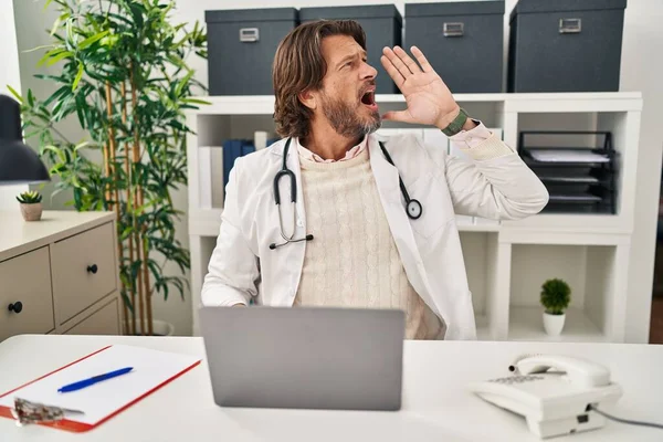 Handsome Middle Age Doctor Man Working Clinic Shouting Screaming Loud — Stock Photo, Image