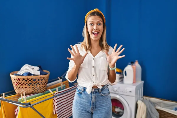 Young Blonde Woman Laundry Room Celebrating Crazy Amazed Success Arms — Stock Photo, Image