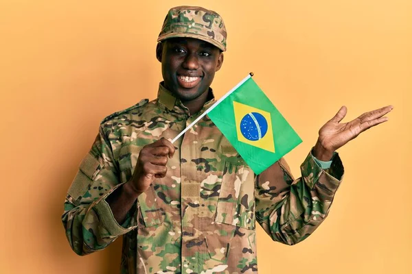 Young African American Man Wearing Army Uniform Holding Brazil Flag —  Fotos de Stock