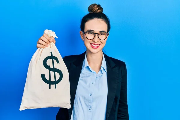 Young Hispanic Girl Wearing Business Clothes Holding Dollars Bag Looking — Fotografia de Stock