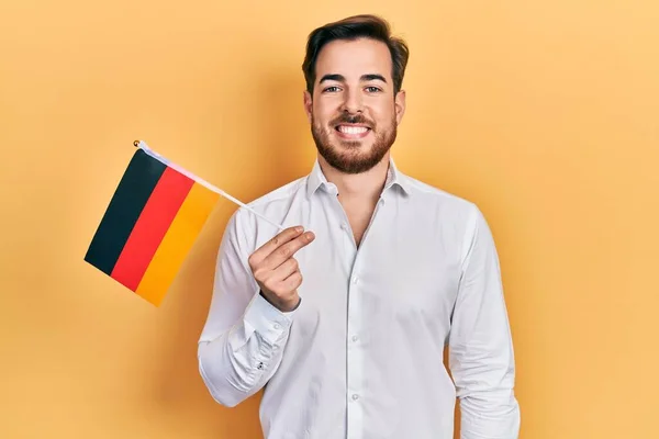 Handsome Caucasian Man Beard Holding Germany Flag Looking Positive Happy — стоковое фото