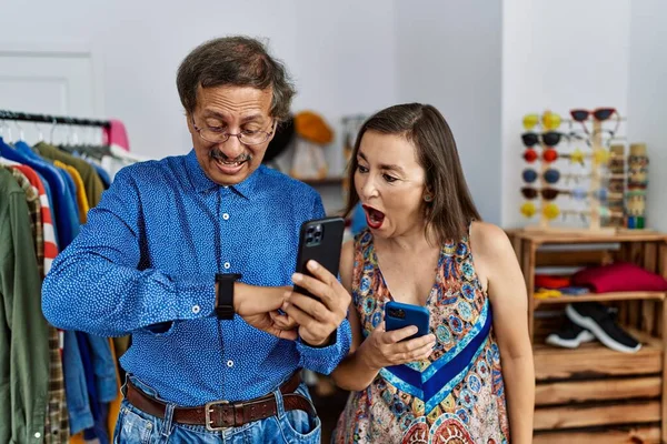 Middle Age Interracial Couple Retail Shop Using Smartphone Looking Watch — Stock Photo, Image