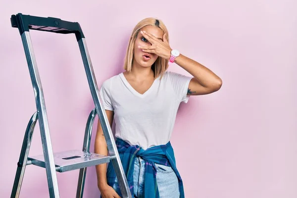 Beautiful Blonde Woman Standing Ladder Peeking Shock Covering Face Eyes — Fotografia de Stock