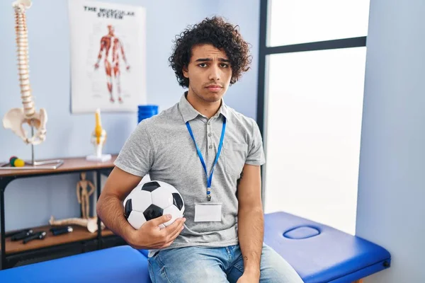 Hispanic Man Curly Hair Working Football Physiotherapist Depressed Worry Distress — Stock fotografie
