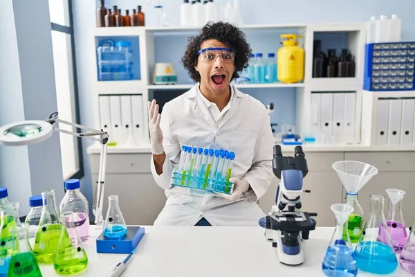 Hispanic Man Curly Hair Working Scientist Laboratory Celebrating Victory Happy — ストック写真