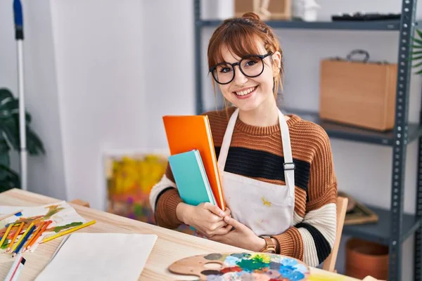 Young Woman Artist Holding Books Sitting Table Art Studio — Stock Photo, Image