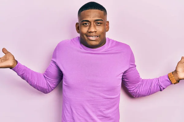 Young Black Man Wearing Casual Pink Sweater Clueless Confused Expression — ストック写真